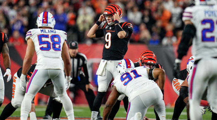 Cincinnati Bengals quarterback Joe Burrow (9) resets a play before running a QB sneak for a first down in the first quarter of the NFL Week 17 game between the Cincinnati Bengals and the Buffalo Bills at Paycor Stadium in Downtown Cincinnati on Monday, Jan. 2, 2023. The game was suspended with suspended in the first quarter after Buffalo Bills safety Damar Hamlin (3) was taken away in an ambulance following a play.